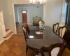 Dining space featuring parquet flooring and a chandelier