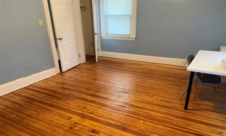 Unfurnished bedroom with hardwood / wood-style floors