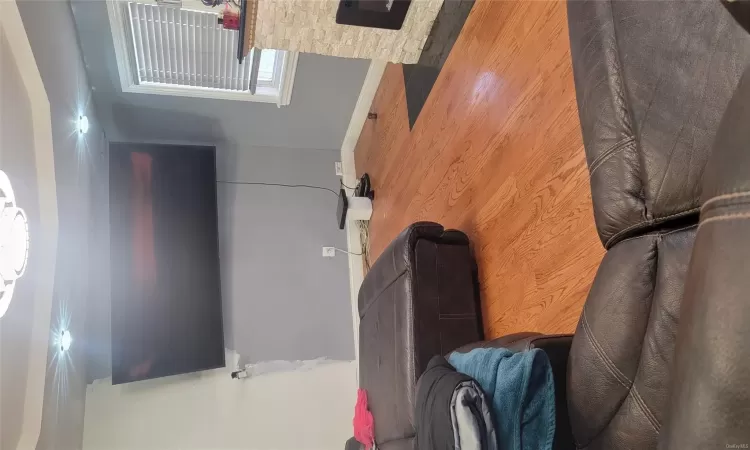 Living room with a fireplace and wood-type flooring