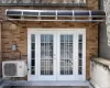 View of patio with ac unit and french doors