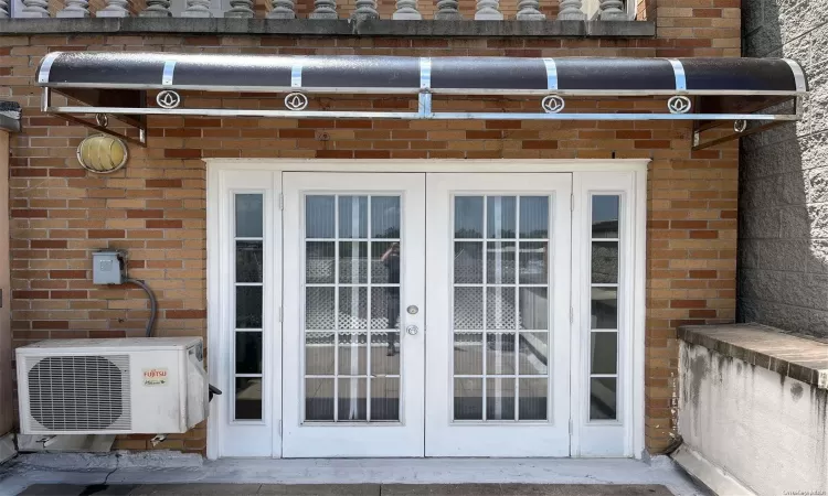 View of patio with ac unit and french doors