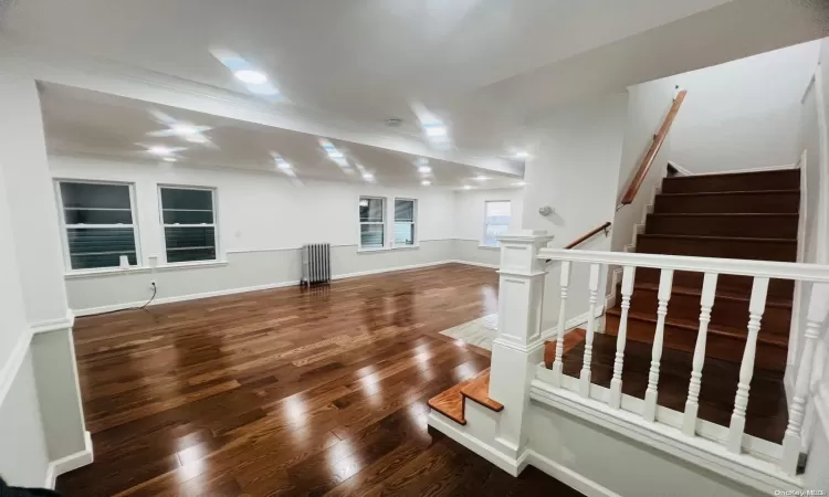 Unfurnished room with a wall mounted air conditioner, dark hardwood / wood-style floors, and crown molding