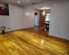 Empty room featuring wood-type flooring and a notable chandelier