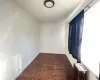 Unfurnished room featuring ornamental molding, dark wood-type flooring, and radiator