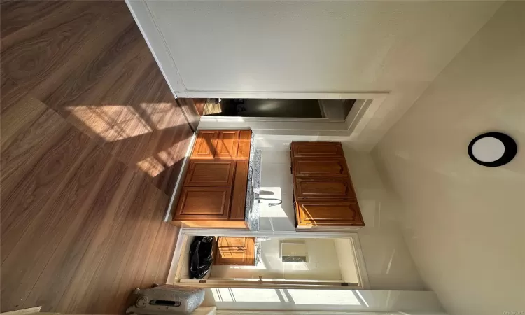 Kitchen featuring dark hardwood / wood-style flooring and sink