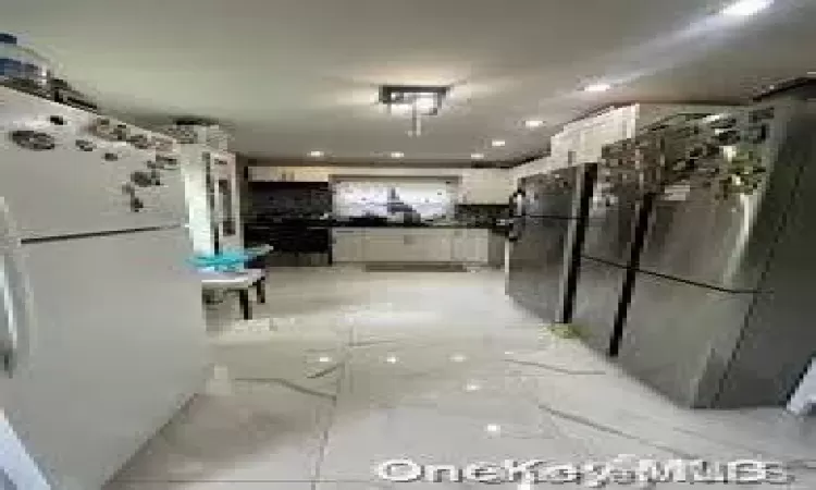 Dining area with light wood-type flooring, lofted ceiling, and a stone fireplace