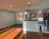 Kitchen featuring hardwood / wood-style flooring, baseboard heating, and a wealth of natural light