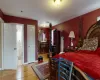 Bedroom featuring ensuite bath and hardwood / wood-style floors