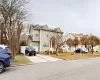 View of front property featuring a garage, a front yard, and solar panels