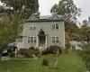 Front of property with a front yard, solar panels, and a garage