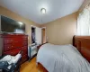 Bedroom featuring a spacious closet, a closet, and light hardwood / wood-style floors