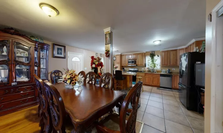 Dining space with light tile patterned floors and decorative columns