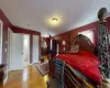 Bedroom with ensuite bathroom and light wood-type flooring