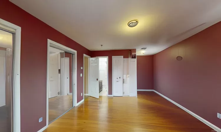 Unfurnished bedroom featuring light wood-type flooring