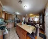 Kitchen featuring a center island, stainless steel appliances, light stone counters, a kitchen bar, and light tile patterned floors