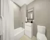 Full bathroom featuring vanity, toilet, and shower / bath combo with shower curtain