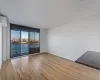 Unfurnished room with a textured ceiling, a wall unit AC, and light hardwood / wood-style flooring