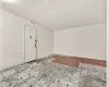 Basement with light hardwood / wood-style floors