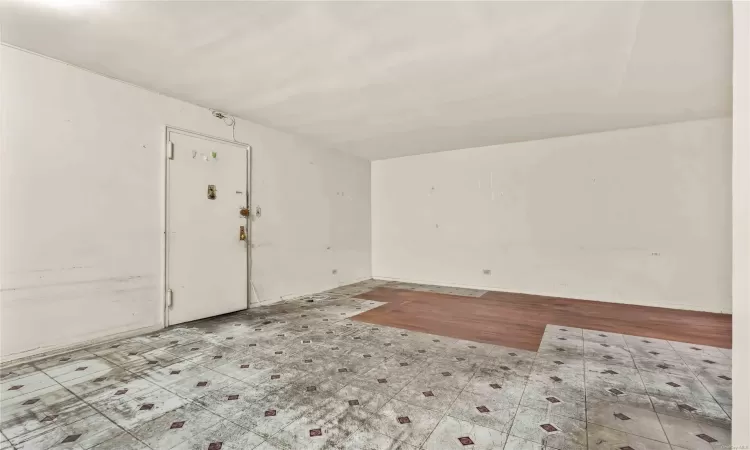 Basement with light hardwood / wood-style floors