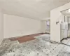 Unfurnished living room featuring light hardwood / wood-style floors and radiator