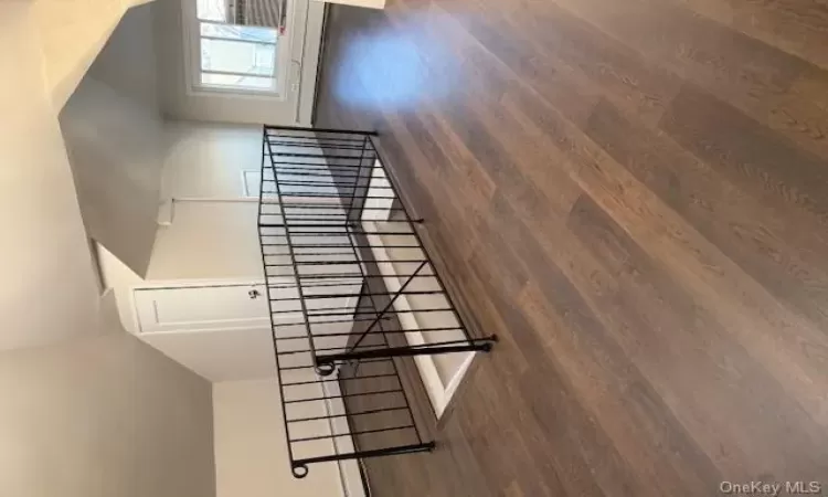 Bonus room featuring baseboard heating, lofted ceiling, and dark hardwood / wood-style floors