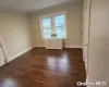 Washroom with dark hardwood / wood-style flooring and independent washer and dryer