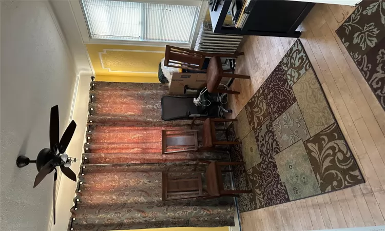 Sitting room featuring a textured ceiling, light hardwood / wood-style flooring, radiator, and ceiling fan