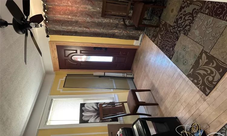 Foyer with ceiling fan, light hardwood / wood-style floors, and a textured ceiling