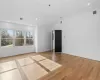 Spare room featuring light hardwood / wood-style flooring and vaulted ceiling