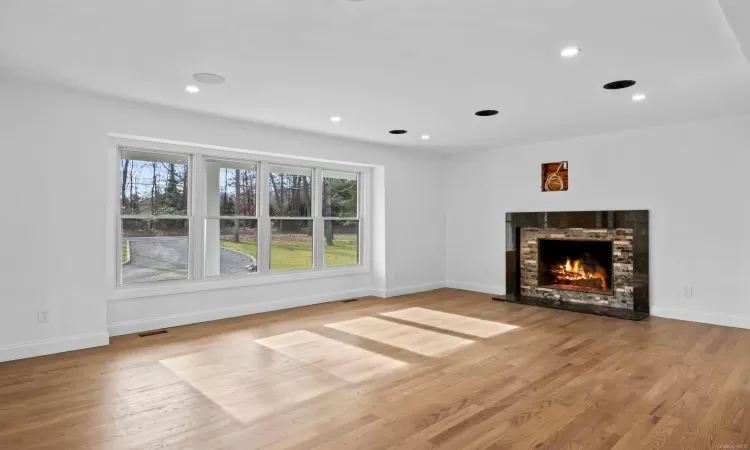 Unfurnished living room with light hardwood / wood-style floors and a fireplace