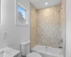 Full bathroom featuring vanity, toilet, and tiled shower / bath