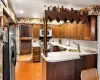 Kitchen featuring a kitchen breakfast bar, kitchen peninsula, sink, and stainless steel appliances