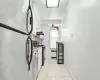 Kitchen featuring light tile patterned floors, stainless steel appliances, and white cabinetry