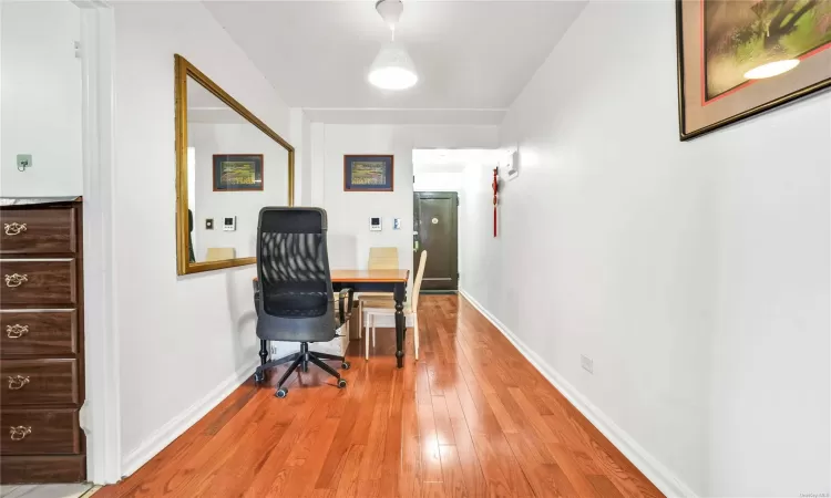 Office with light hardwood / wood-style flooring