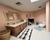 Bathroom featuring tile patterned flooring, vanity, and toilet