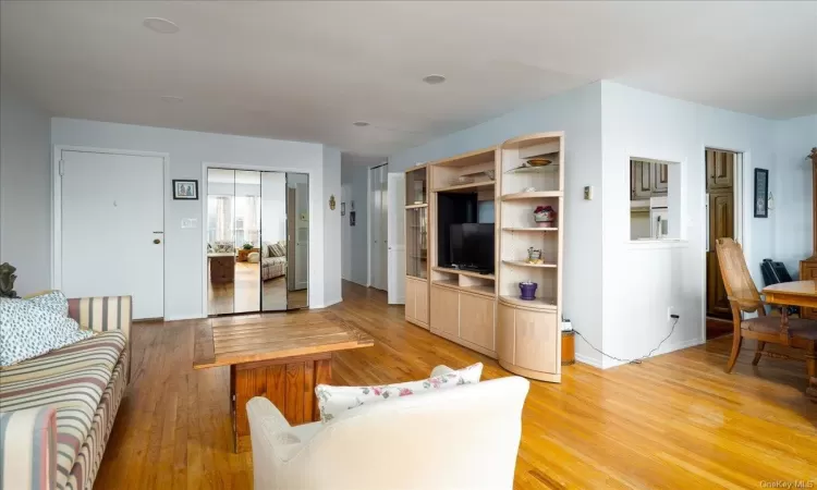 Living room with light hardwood / wood-style floors and baseboard heating