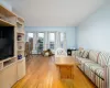 Living room featuring a baseboard heating unit and light wood-type flooring