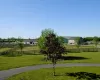 View of home's community featuring a rural view and a yard