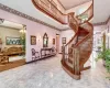 Stairs with a chandelier and a high ceiling