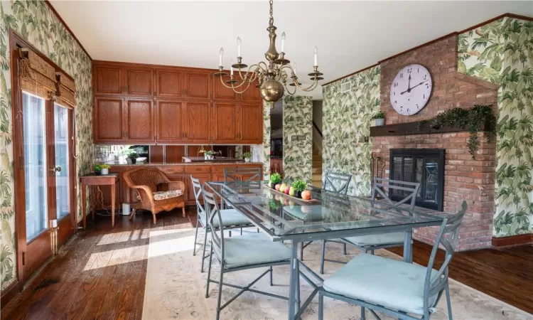 Entryway featuring dark hardwood / wood-style flooring, ornamental molding, and a wealth of natural light