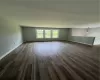 Spare room featuring a baseboard radiator and dark wood-type flooring