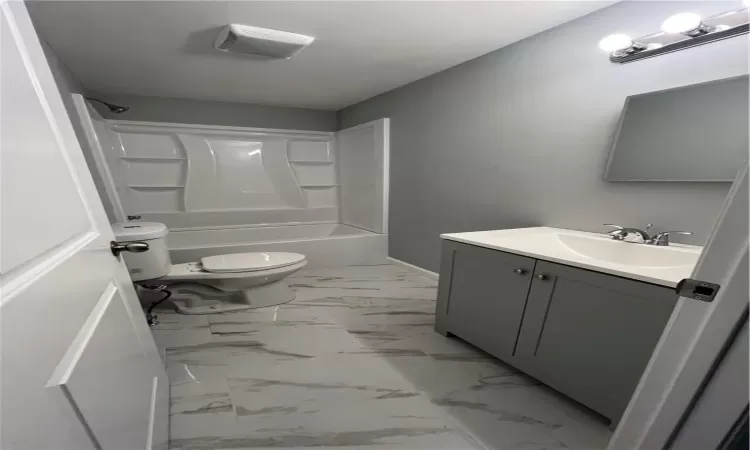 Full bathroom with tile flooring, shower / bath combination, toilet, and vanity