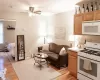 Living room with ceiling fan and light hardwood / wood-style flooring