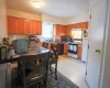 Kitchen with sink, light tile flooring, and white appliances