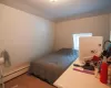 Bedroom with a baseboard radiator and carpet floors