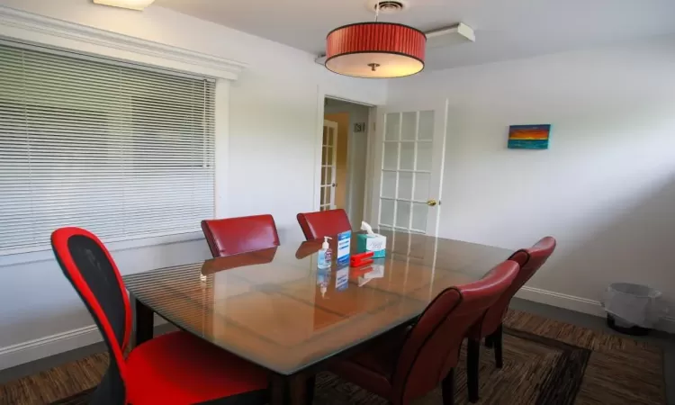 Dining room with dark colored carpet