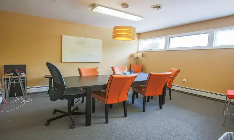 Dining room with baseboard heating and carpet