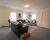 Living room featuring carpet floors, a baseboard radiator, a wealth of natural light, and a wall mounted AC