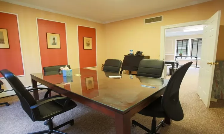 Carpeted office featuring ornamental molding