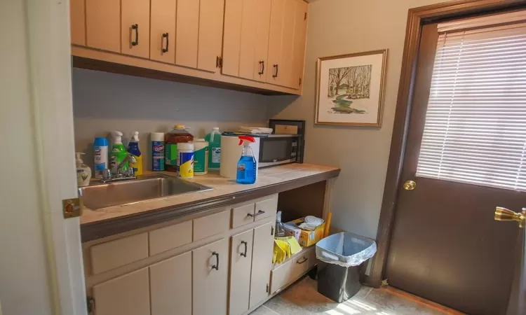 Bathroom featuring tile floors, plenty of natural light, and sink